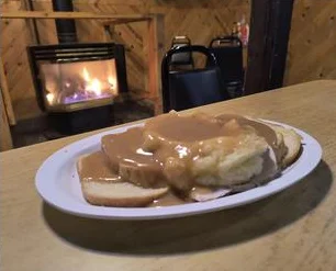 Fireplace and plate of biscuits and gravy